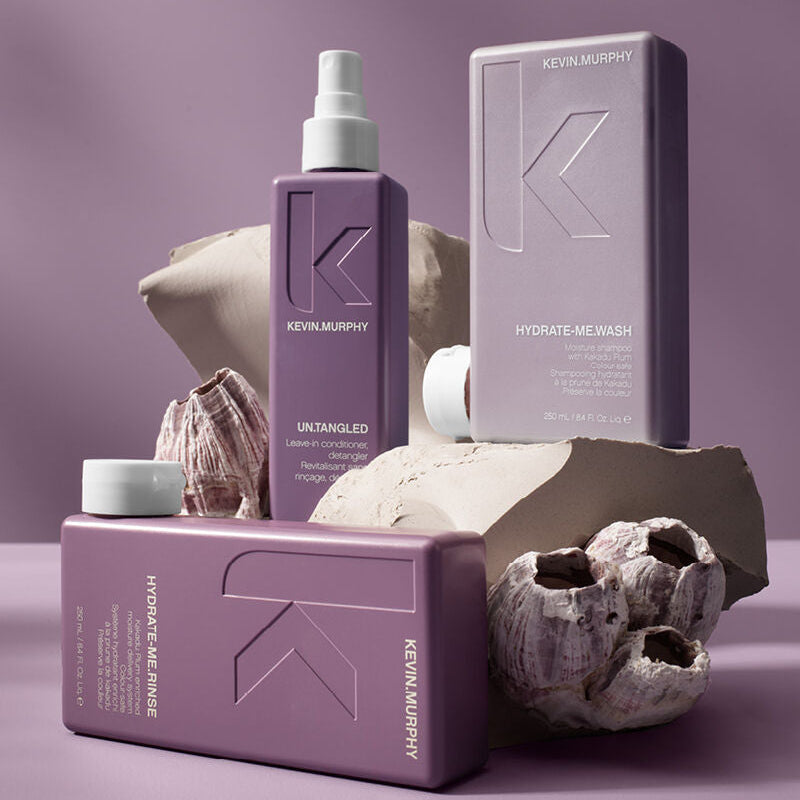 Kevin Murphy hair care products on a purple background with seashells.