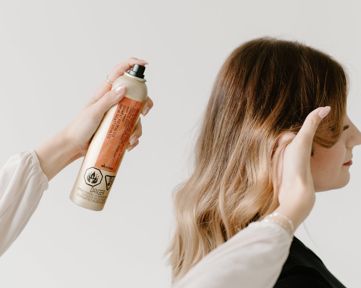 davines dry shampoo being sprayed onto clients hair