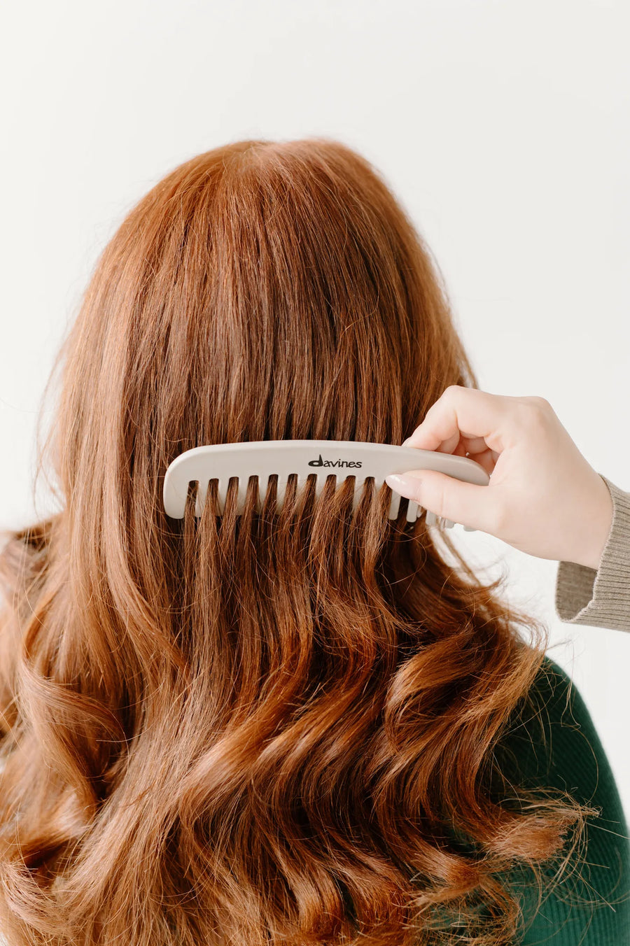 Moda Salon combing red hair with a Davines wide-tooth comb