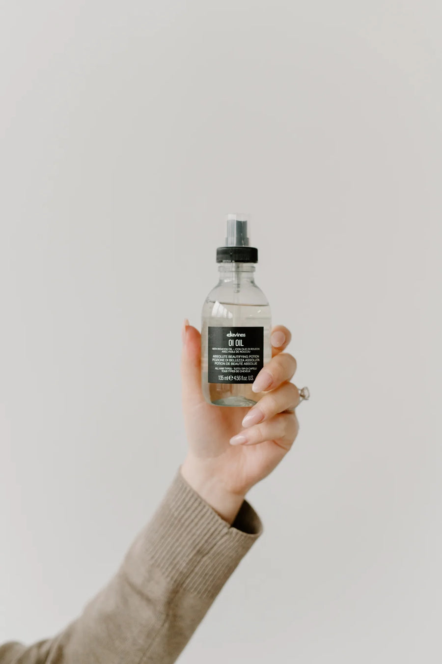 Moda Salon stylist holding a Davines hair mist