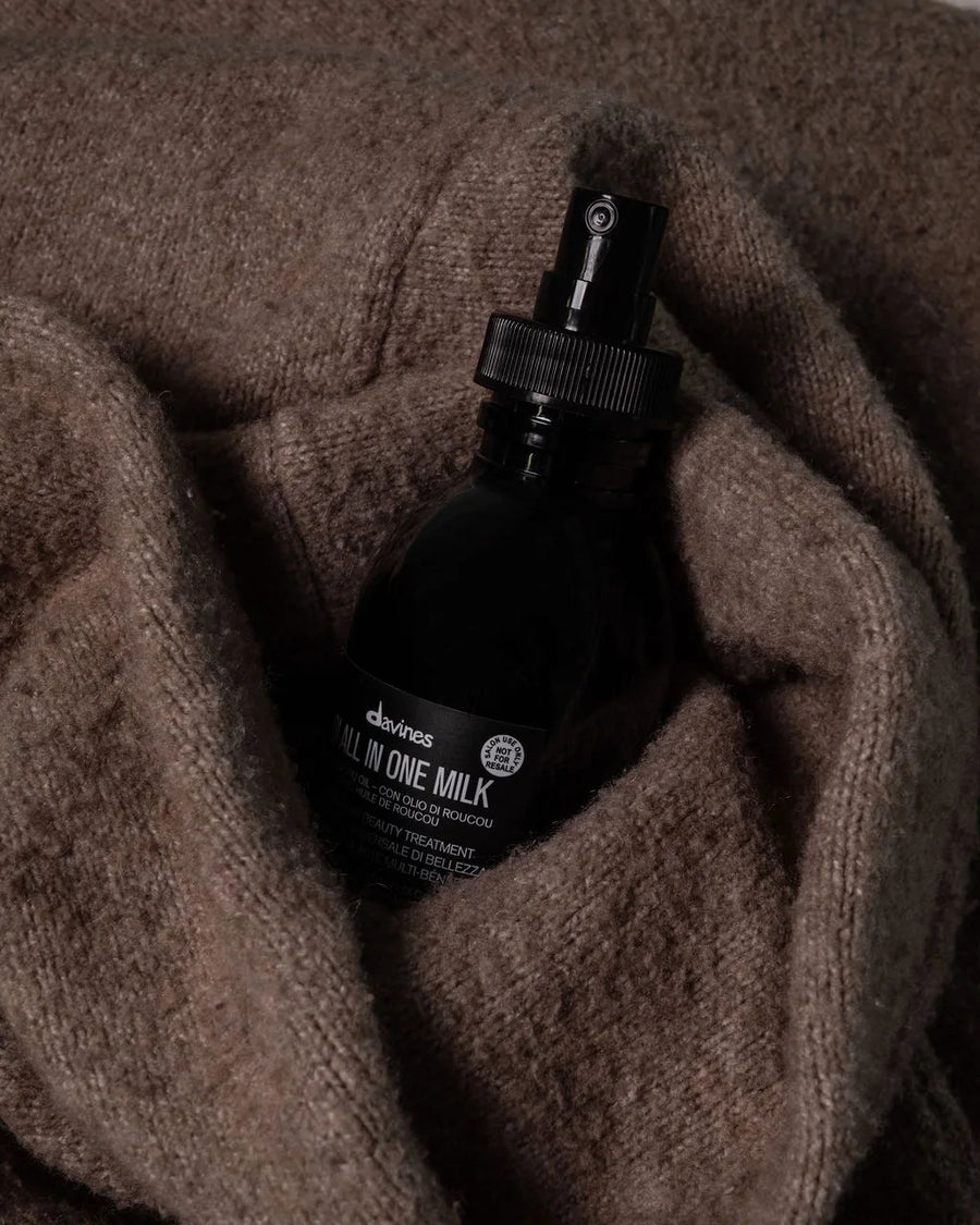 Moda Salon Davines OI All In One Milk on a knit sweater