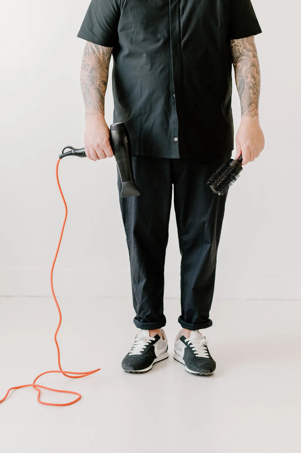 Moda Salon stylist Kris with blow dryer and orange cord