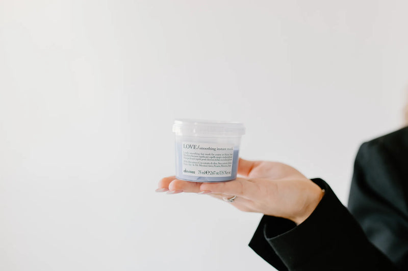 Moda Salon stylist holding product jar