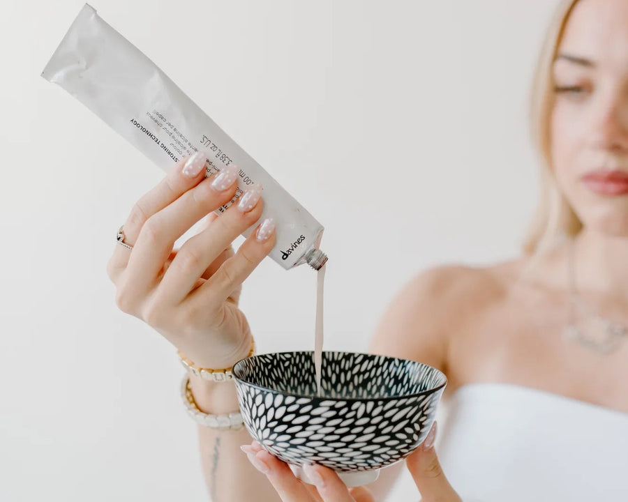 Moda Salon stylist mixing hair colour in a bowl