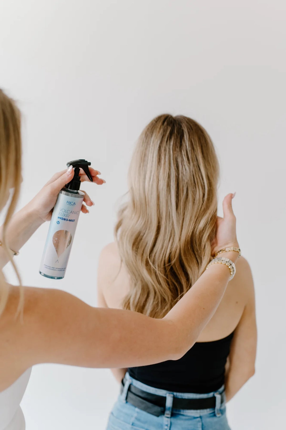 Moda Salon stylist spraying blonde hair