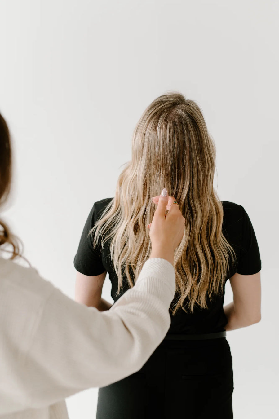 Moda Salon stylist styling blonde hair, back view