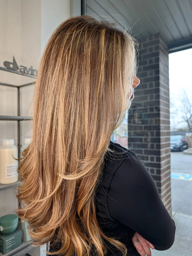 Thick warm honey brunette hair with long layers