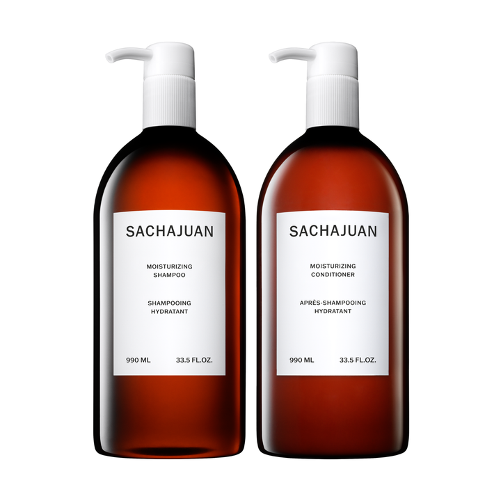 Two brown bottles with white labels, one labeled as Sachajuan Moisturizing Shampoo and the other as Conditioner, each with a pump dispenser and capacity of 990ml. 