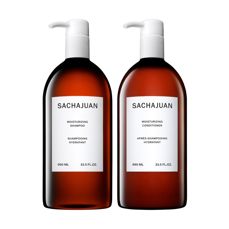 Two brown bottles with white labels, one labeled as Sachajuan Moisturizing Shampoo and the other as Conditioner, each with a pump dispenser and capacity of 990ml. 